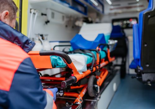 Close-up of empty stretcher inside ambulance vehicle.