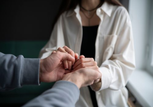 Gentle Male and Female Hands Offering Comfort and Support in a Time of Need